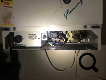 Potterton Flamingo temperature controls showing temperature control knob, gas valve and igniter button.